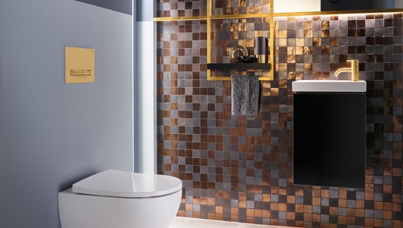 Powder room with metallic tile and brass accents, Geberit Sigma50 flush plate in brushed brass