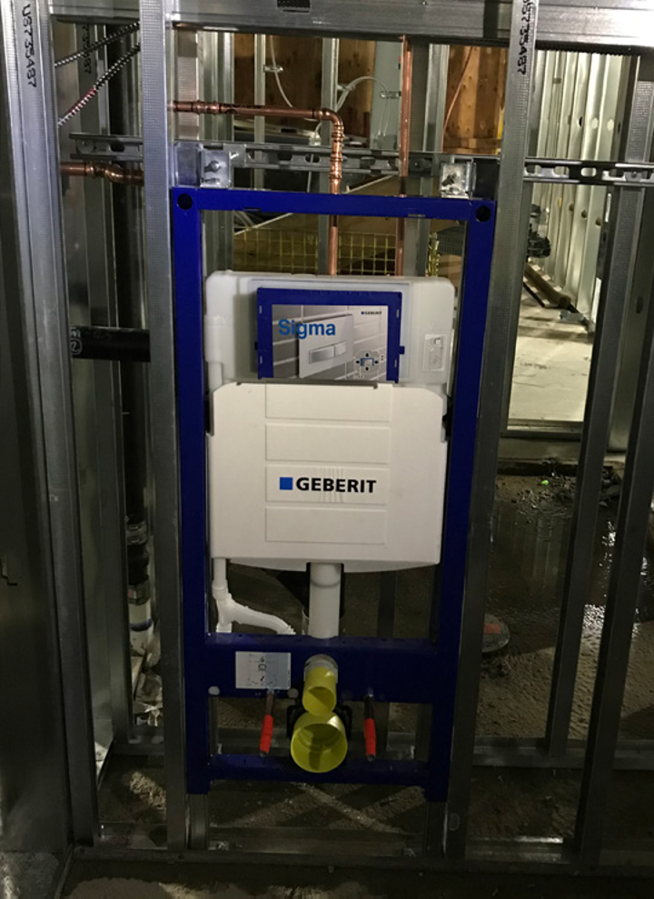 Geberit in-wall toilet system being installed in Citizen M hotel under construction