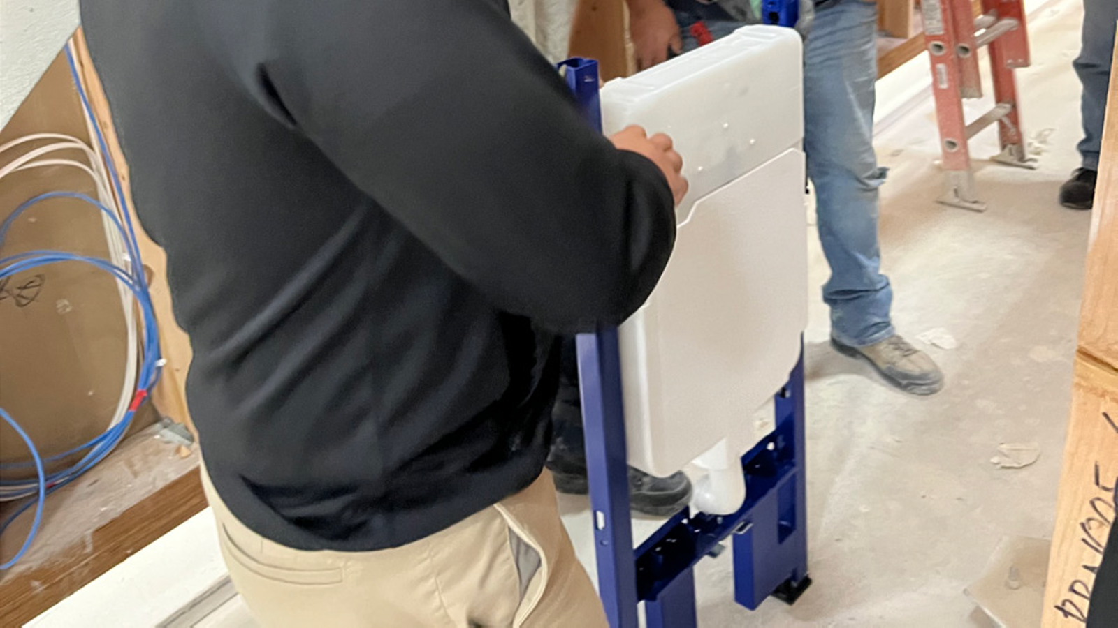 Closeup of installer with Geberit in-wall system Closeup of installer with Geberit in-wall system