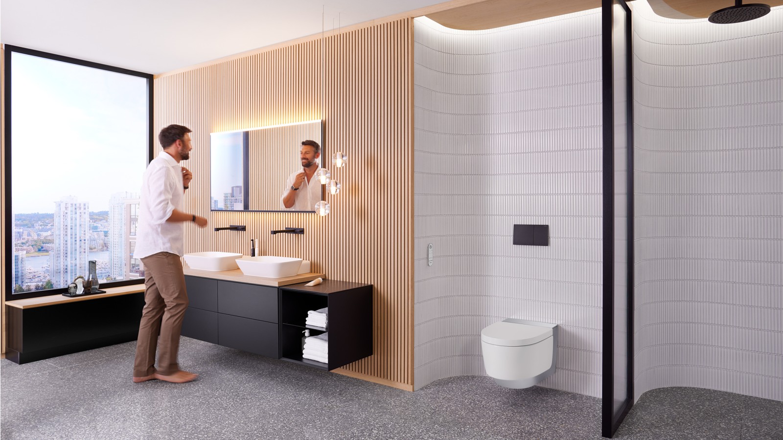 Man in bathroom standing in front of the bathroom mirror and black bathroom furniture (© Geberit) Man in bathroom standing in front of the bathroom mirror and black bathroom furniture (© Geberit)