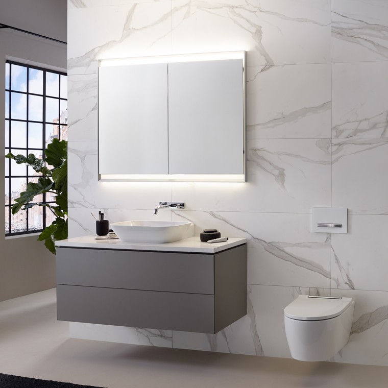 Wall with marble tiles, washbasin, and mirror cabinet with light Wall with marble tiles, washbasin, and mirror cabinet with light