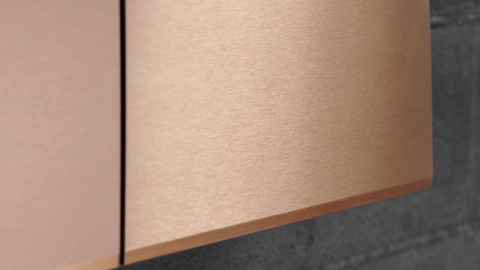 Closeup of Geberit Sigma70 flush actuator plate in red gold finish Closeup of Geberit Sigma70 flush actuator plate in red gold finish