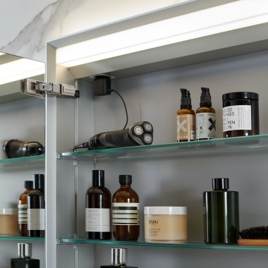 Open Geberit mirror cabinet in which bathroom items are stored