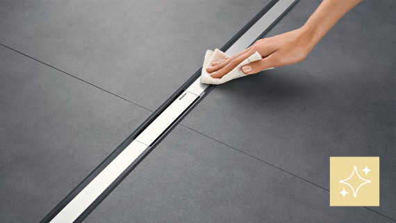 Woman cleaning a zero-entry shower channel