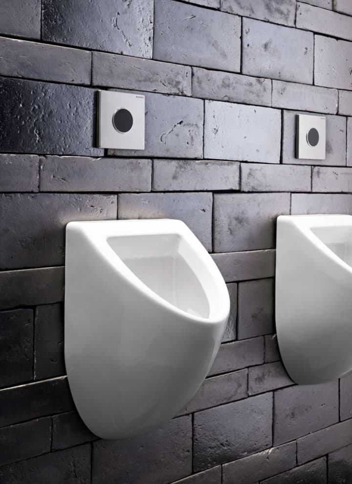Type 10 urinal flush plates on stone wall Type 10 urinal flush plates on stone wall