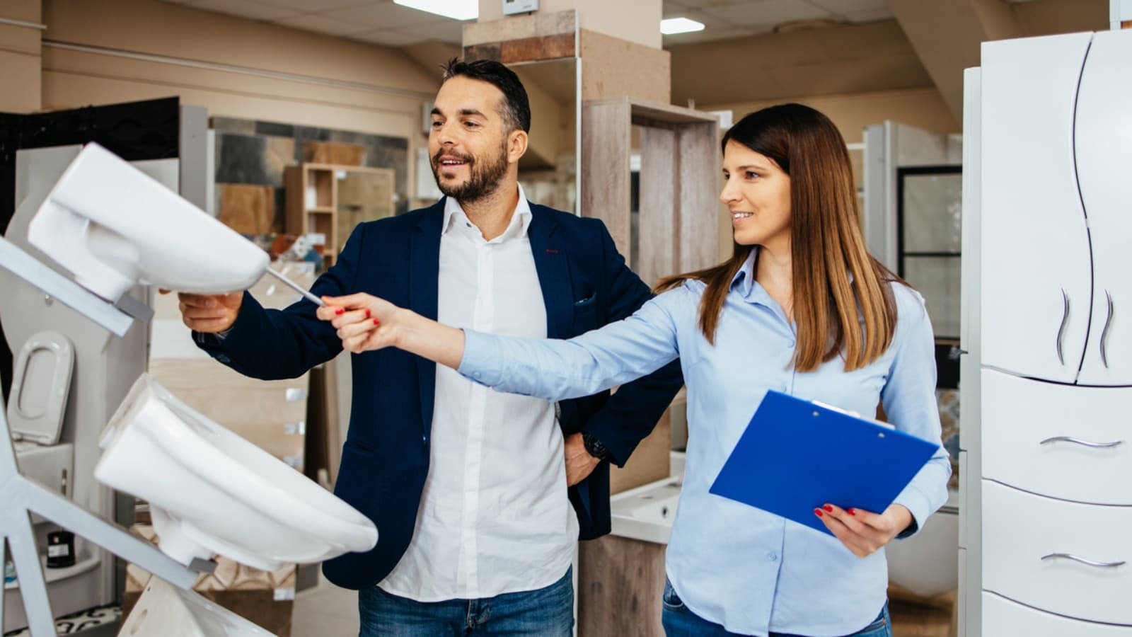 A man and woman choose between toilet shapes. A man and woman choose between toilet shapes.