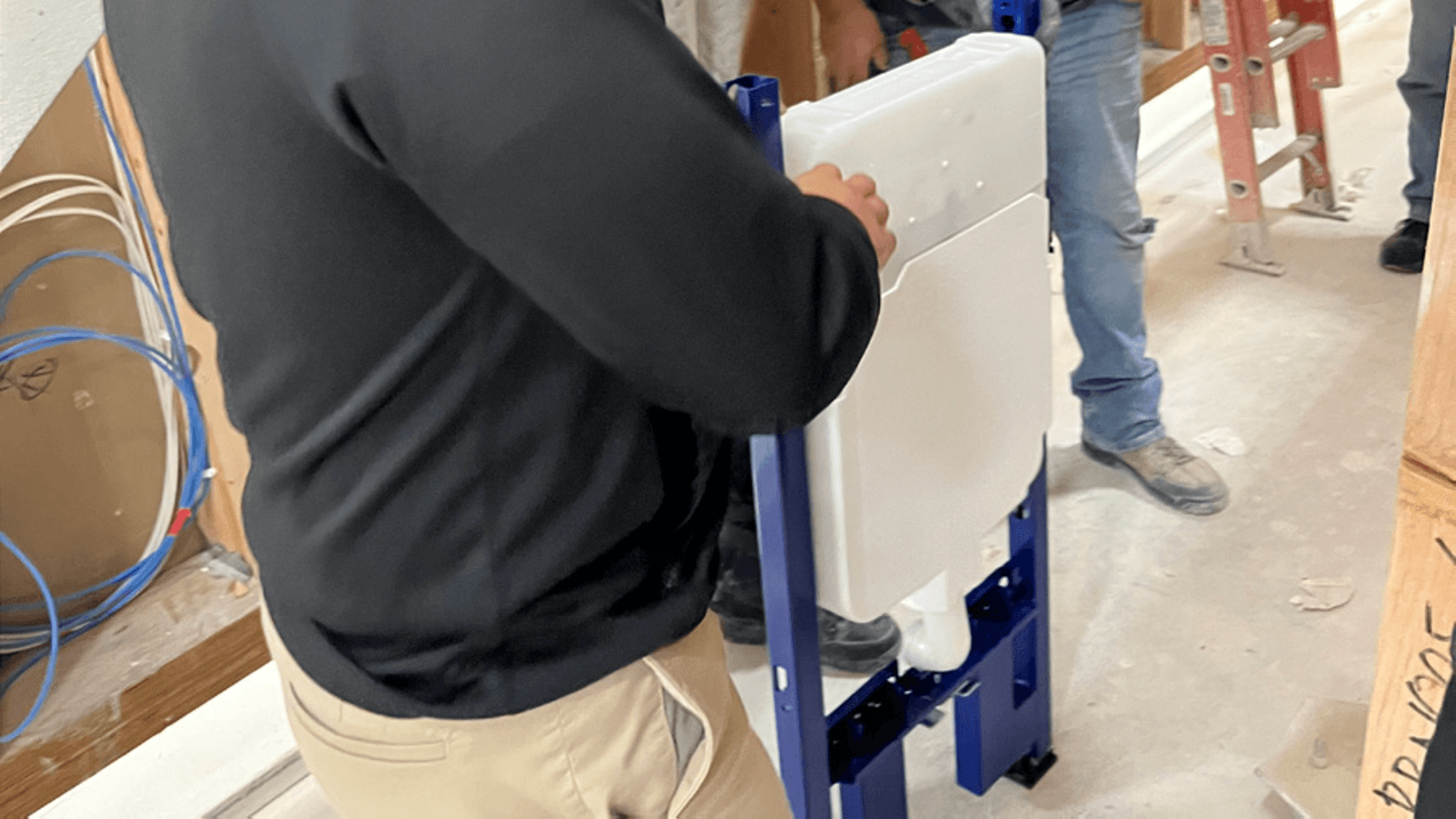 Closeup of installer with Geberit in-wall system Closeup of installer with Geberit in-wall system