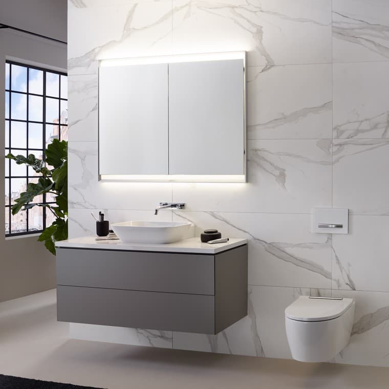 Wall with marble tiles, washbasin, and mirror cabinet with light Wall with marble tiles, washbasin, and mirror cabinet with light